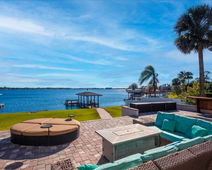 A patio with furniture and a view of the water in Fairview Shores, Orlando, Florida