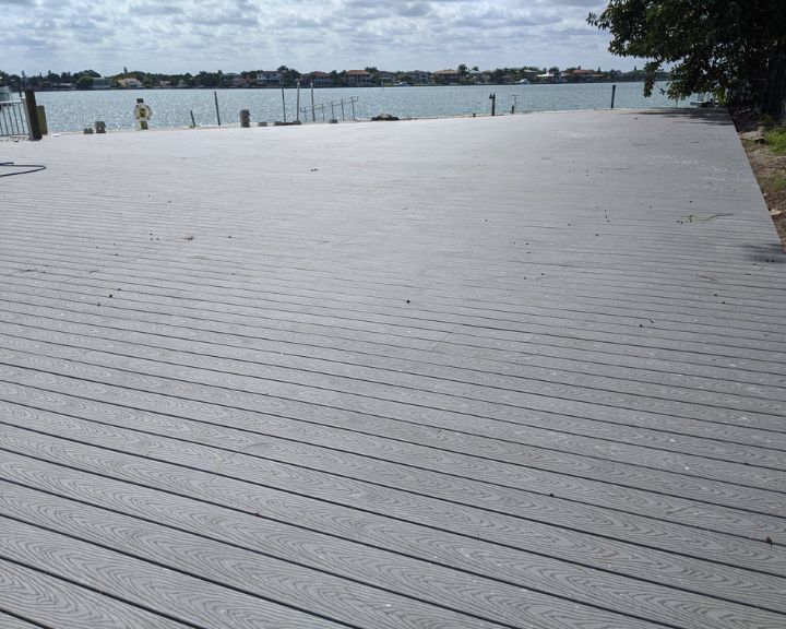 A new grey composite decking installed on the shoreline at a property in Orlando.