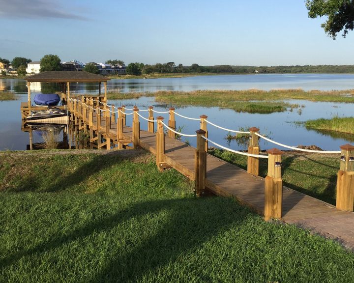 A wooden dock leading to a body of water in Orlando.