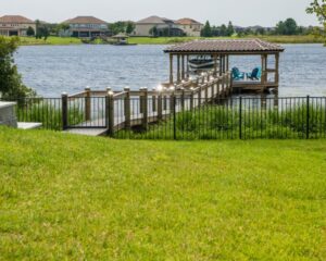 A dock on a lake in front of a house in Orlando.
