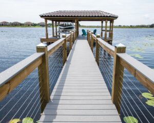 Orlando Dock Builders constructed a wooden dock leading to a house on a lake.