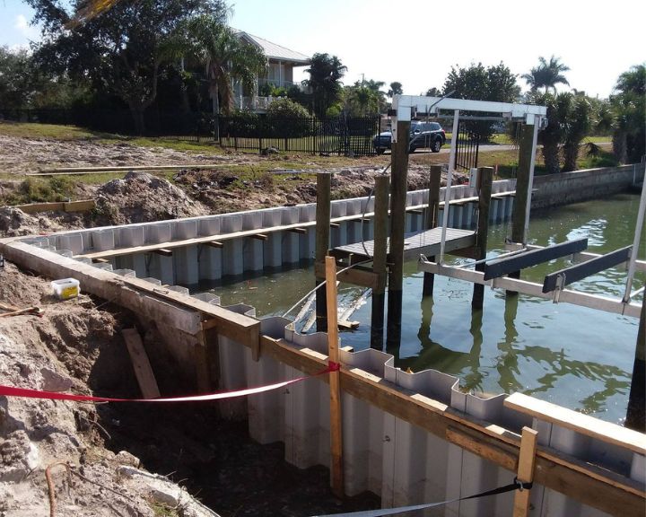 Orlando Dock Builders are constructing a boat dock in the water.