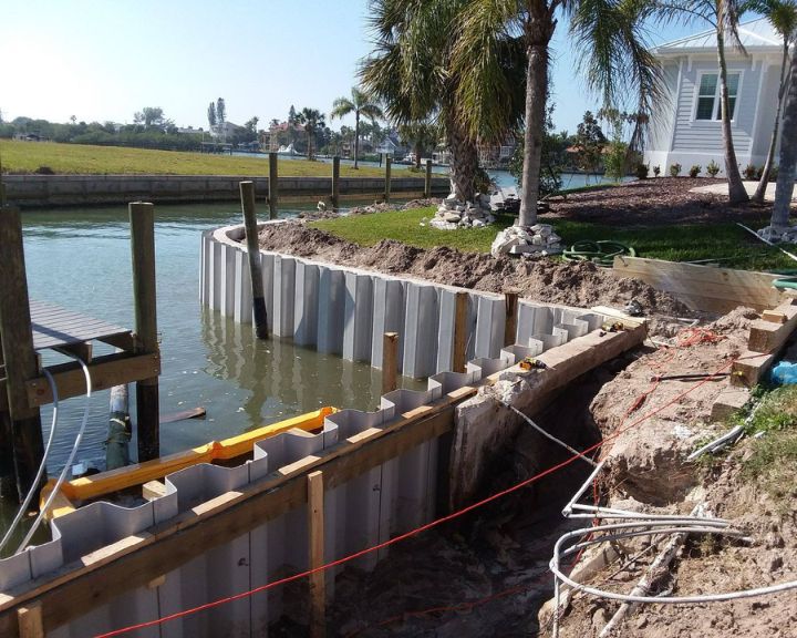 Orlando Dock Builders are currently constructing a dock in the water adjacent to a house.