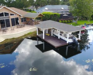 An aerial view of a house with an Orlando dock and boat.