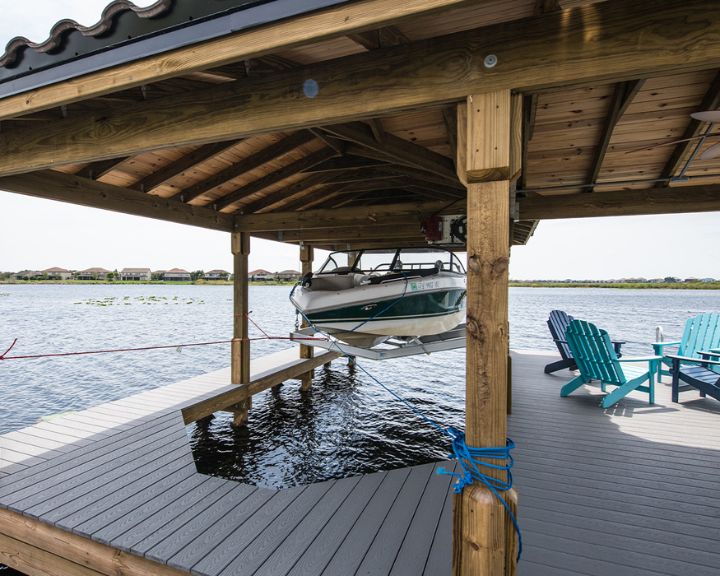 Orlando Dock Builders construct a sturdy wooden dock featuring a boat.