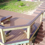 A wooden deck with stairs and a bench.
