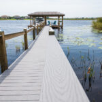 A wooden dock leading to a body of water.
