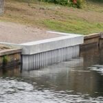 A waterway with a concrete retaining wall.