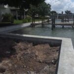 A dock is being built next to a body of water.