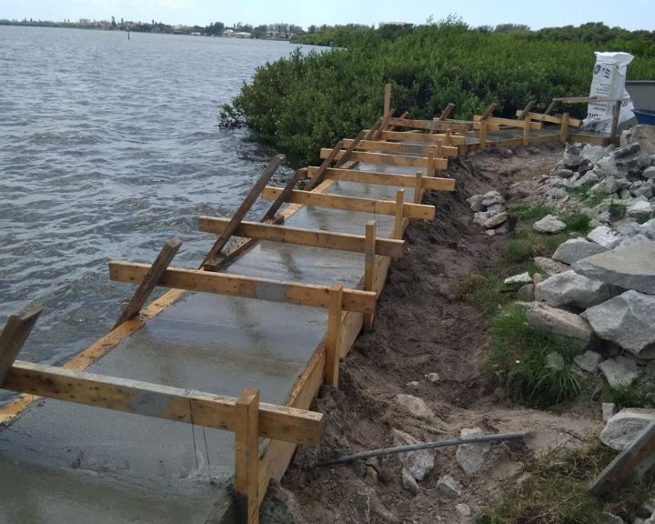A concrete seawall being repaired by dock builders in Orlando.